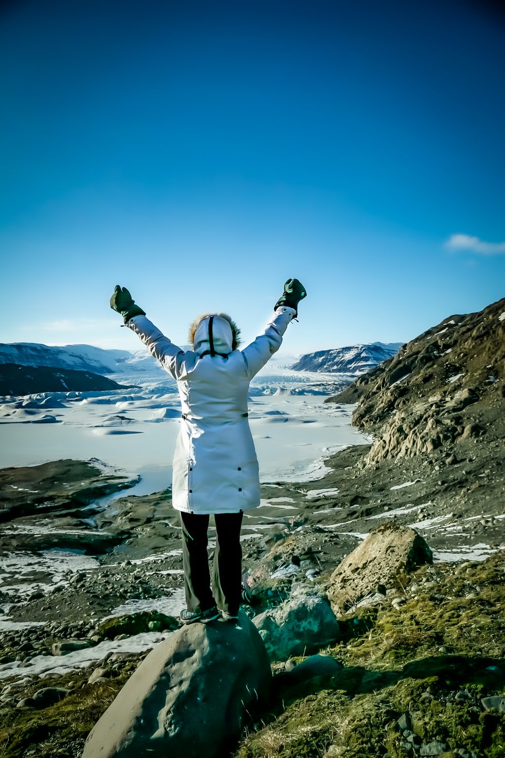 Arms raised at a glacier lagoon
